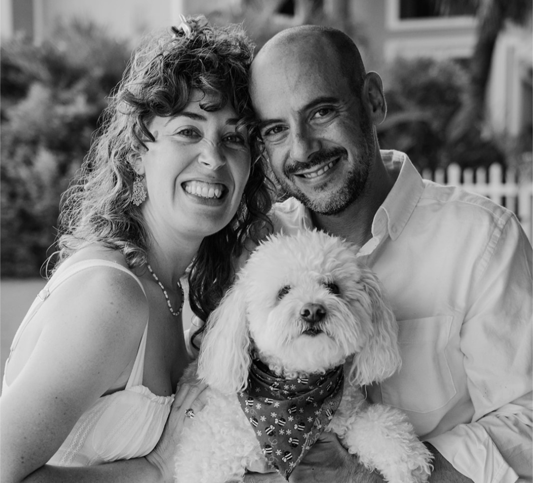Black and white photo of Natalie and Ari with their dog
